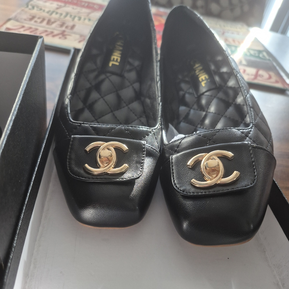 CHANEL Black Leather. Quilted Flats with Gold Emblem. The Bag and Box Included.